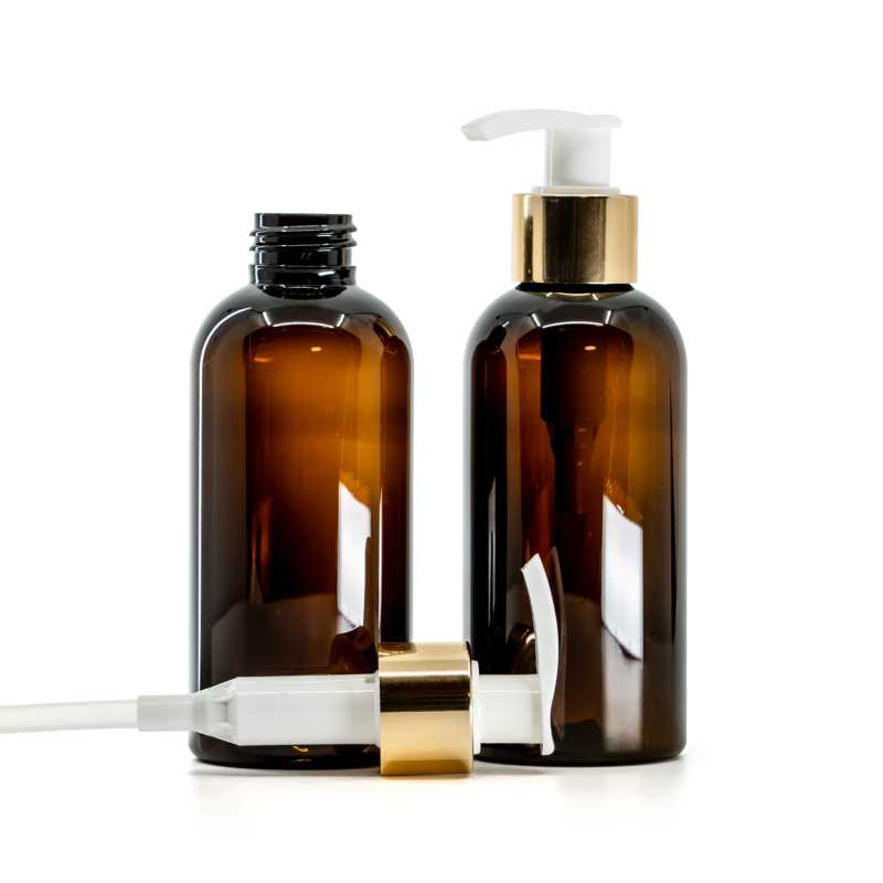 Bernsteinfarbene Kunststoffflasche, weiße Lotionpumpe mit glänzendem Goldkragen, 150 ml