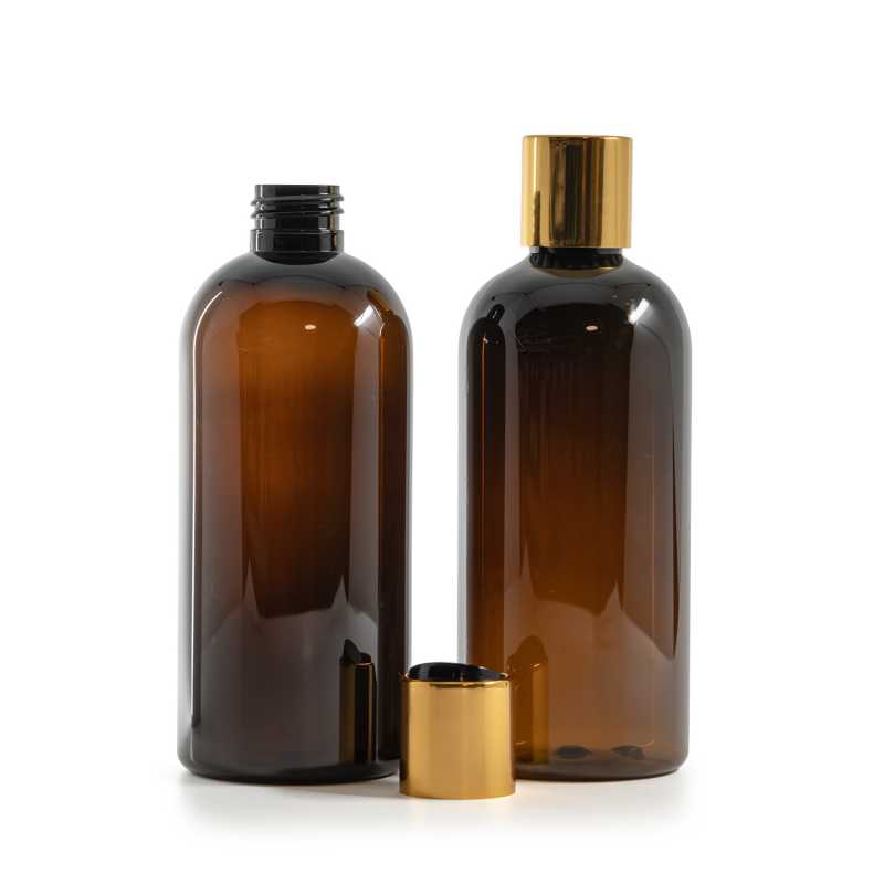 Bernsteinfarbene Kunststoffflasche, schwarzer Kunststoff-Kippverschluss mit goldenem Aluminiumkragen