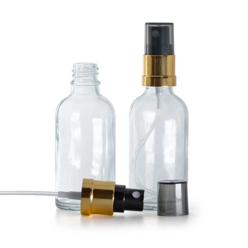 Klare Glasflasche, schwarzer Sprühkopf mit glänzender Goldhülse, rauchfarbener Überkappe, 50 ml