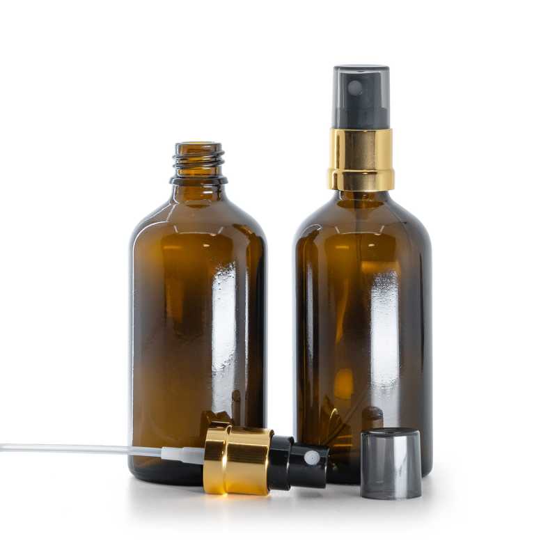 Braunglasflasche, gold-schwarzer Sprühkopf, rauchfarbener Überkappe 100 ml
